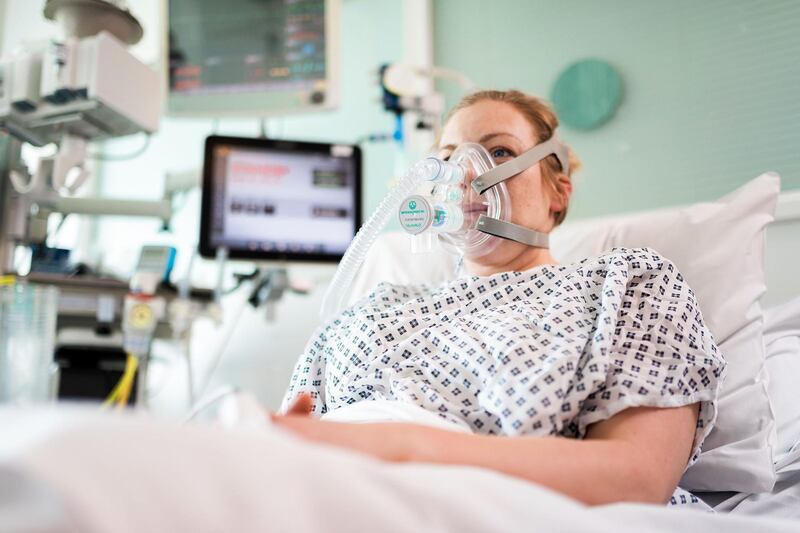 An undated handout image released by University College London (UCL) in London and received on March 30, 2020, shows a volunteer patient posing whilst wearing the Continuous Positive Airway Pressure (CPAP) breathing aid, developed in less than a week by mechanical engineers, doctors and the Mercedes Formula 1 team in conjunction with UCL. Medical researchers and engineers at UCL have teamed up with Formula One outfit Mercedes to adapt a breathing aid for mass production that could keep coronavirus patients off much-needed ventilators. 
University College London said UK regulators had approved its adaptation of the continuous positive airway pressure device (CPAP), which helps patients with breathing difficulties. A version of the equipment, which increases air and oxygen flow into the lungs, has already been used in hospitals in Italy and China to help COVID-19 patients with serious lung infections. - RESTRICTED TO EDITORIAL USE - MANDATORY CREDIT "AFP PHOTO / James Tye/ UCL / Handout " - NO MARKETING - NO ADVERTISING CAMPAIGNS - DISTRIBUTED AS A SERVICE TO CLIENTS
 / AFP / University College London (UCL) / James Tye / RESTRICTED TO EDITORIAL USE - MANDATORY CREDIT "AFP PHOTO / James Tye/ UCL / Handout " - NO MARKETING - NO ADVERTISING CAMPAIGNS - DISTRIBUTED AS A SERVICE TO CLIENTS
