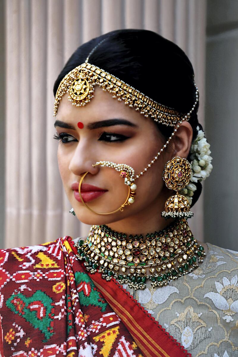 This look shows Kishandas & Co jewels including a choker, extended nose ring, maatha-patti along the forehead and maang-tikka in the hair parting, along with a hand-woven outfit by Gaurang Shah. Courtesy Numaish  