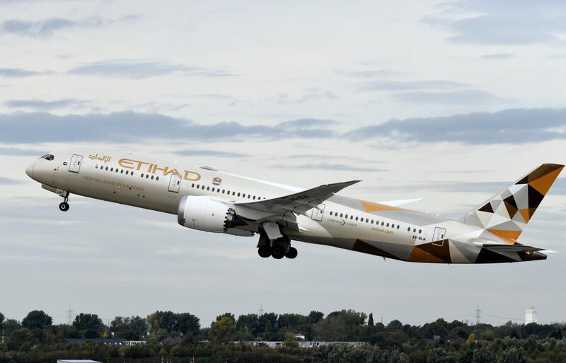 This picture shows a Boeing 787-10 Dreamliner of the Etihad airline during take-off on September 24, 2019 at the airport in Duesseldorf, western Germany. (Photo by INA FASSBENDER / AFP)