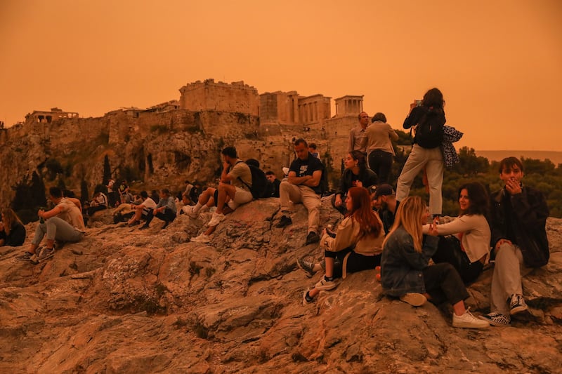 People gathered in the Acropolis area as African dust turned the sky of Athens orange. Skies in southern Greece were transformed as dust clouds blew in from North Africa. EPA