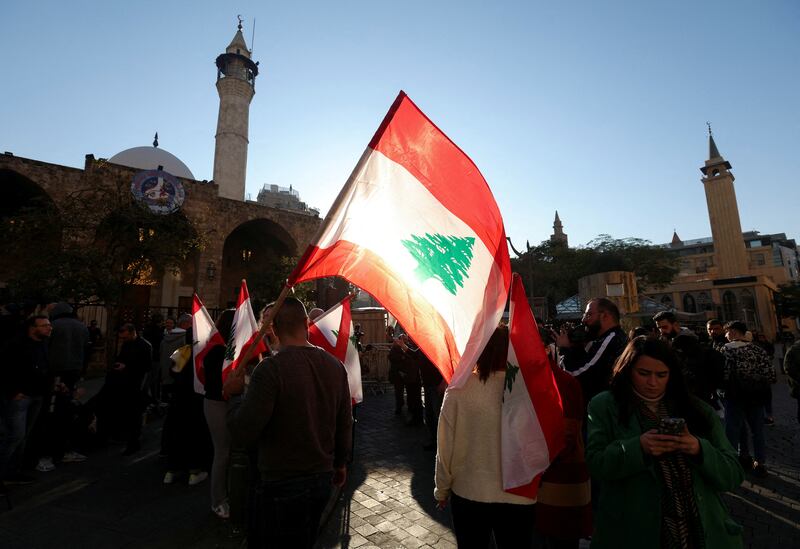 Protesters carry flags near the entrance leading to the parliament building, in support of independent lawmakers who are staging a sit-in at parliament to pile pressure on dominant factions to elect a new president, in Beirut, on January 20. Reuters