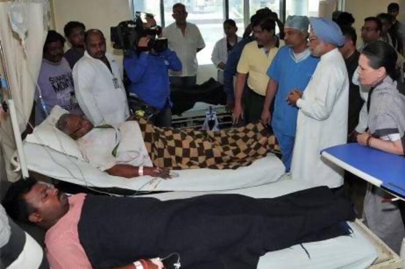India's prime minister Manmohan Singh (second from right) and Sonia Gandhi (right), chief of India's ruling Congress party, meet with victims injured in an ambush at a hospital in the eastern Indian city of Raipur.