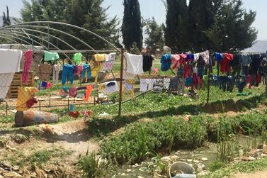 Refugees' laundry strung over a fence in the documentary 'Men on Hold'. Courtesy Forward Film Productions / Muna Khalidi