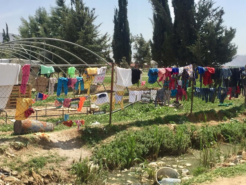 Refugees' laundry strung over a fence, in the documentary Men on Hold. Courtesy Forward Film Productions/Muna Khalidi