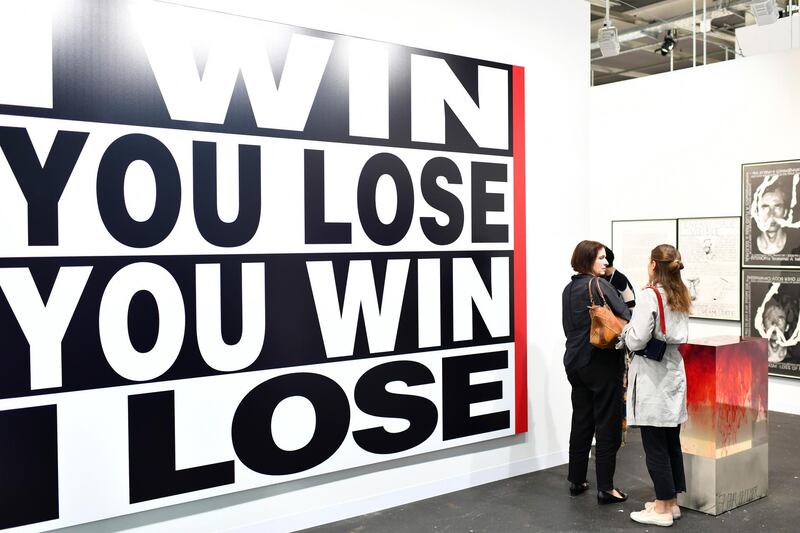 BASEL, SWITZERLAND - JUNE 13:  Visitors look at the artwork of Barbara Kruger "Untitled" during the press preview for Art Basel at Basel Messe on June 13, 2018 in Basel, Switzerland. Art Basel is one of the most prestigious art fair in the world showcasing the work of more than 4,000 artists selected by 300 leading art galleries.  (Photo by Harold Cunningham/Getty Images)