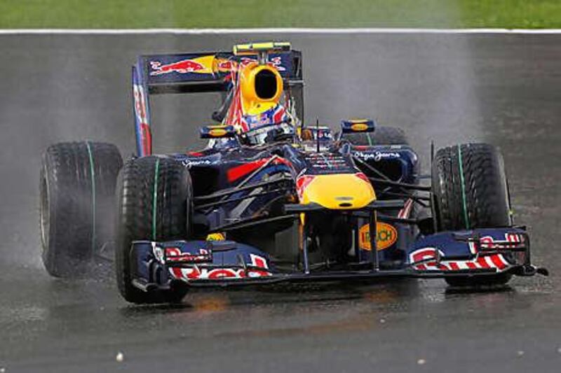 Red Bull's Mark Webber takes a curve on the rain-soaked track during practice at Spa yesterday for the Belgian Grand Prix.