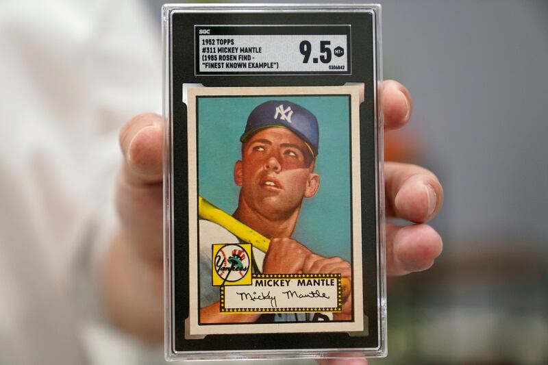 A mint condition Mickey Mantle baseball card was sold for a record $12.6 million during auction. AP