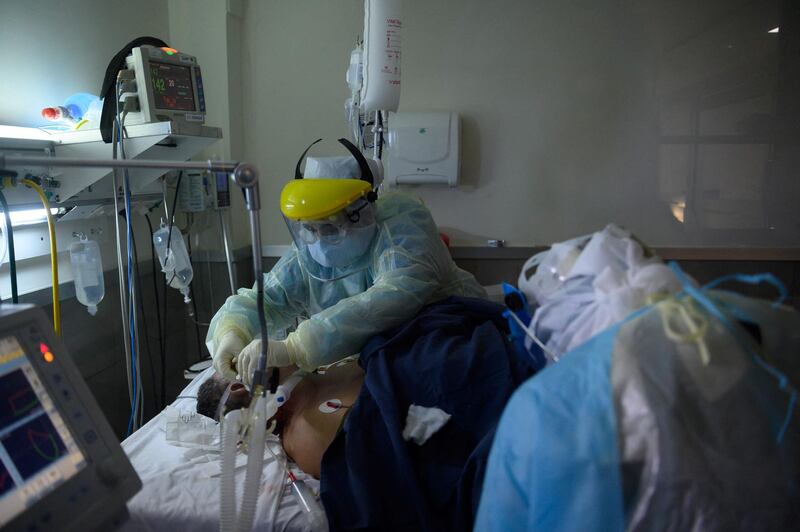 Health workers assist a patient at a Covid-19 Intensive Care Unit in a private hospital in Montevideo, Uruguay. AFP