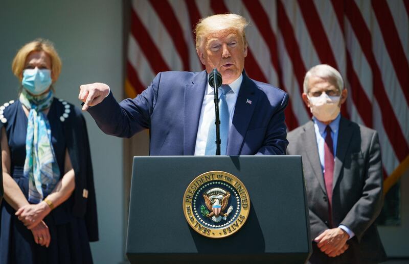 (FILES) In this file photo taken on May 15, 2020 US President Donald Trump speaks on vaccine development in the Rose Garden of the White House in Washington, DC, flanked by White House Coronavirus Task Force Deborah Birx and Director of the National Institute of Allergy and Infectious Diseases Anthony Fauci.  Former US president Donald Trump on March 29, 2021 lashed out at two of the country's leading figures in the coronavirus battle after they criticized his handling of the pandemic. In an angry statement, Trump described Anthony Fauci and Deborah Birx as "two self-promoters trying to reinvent history to cover for their bad instincts and faulty recommendations, which I fortunately almost always overturned." / AFP / MANDEL NGAN
