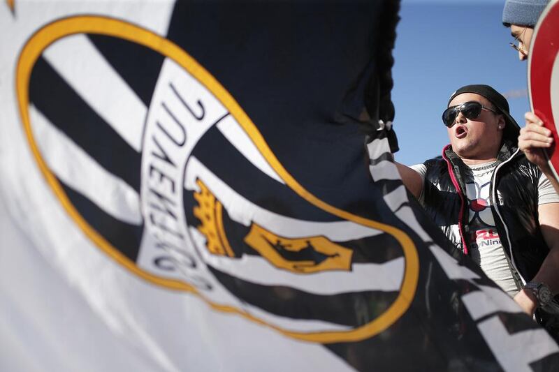 A Juventus supporter celebrates after the football club won the 'scudetto' Serie A title on Sunday. Marco Bertorello / AFP / May 4, 2014