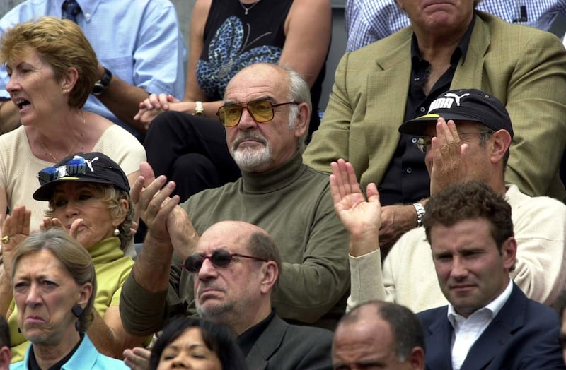 390368 01: Actor Sean Connery, center, and his wife Micheline, left, in Puma hat, applaud during the women''s final of the French Open tennis championship June 9, 2001 at Roland Garros in Paris, France. (Photo by Clive Brunskill/Allsport via Getty Images)