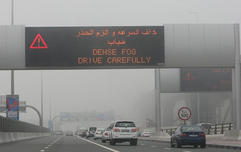 Traffic warning from RTA as fog descends on early morning traffic along Sheikh Zayed road in Dubai. Pawan Singh / The National 