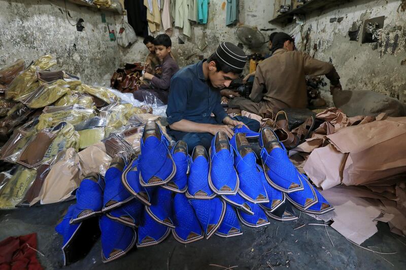 People are seen at a workshop in Peshawar, Pakistan.  Reuters
