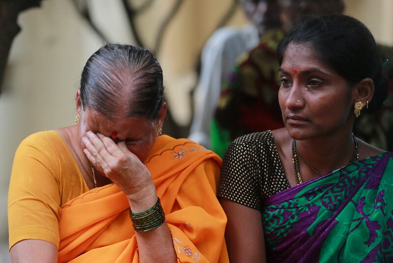 In this Friday, Sept. 29, 2017, file photo, Indians mourn outside a morgue for relatives killed in a pedestrian bridge stampede, in Mumbai, India. The stampede broke out on a crowded pedestrian bridge connecting two railway stations in Mumbai during the Friday morning rush, killing a number of people police said. (AP Photo/Rafiq Maqbool, File)