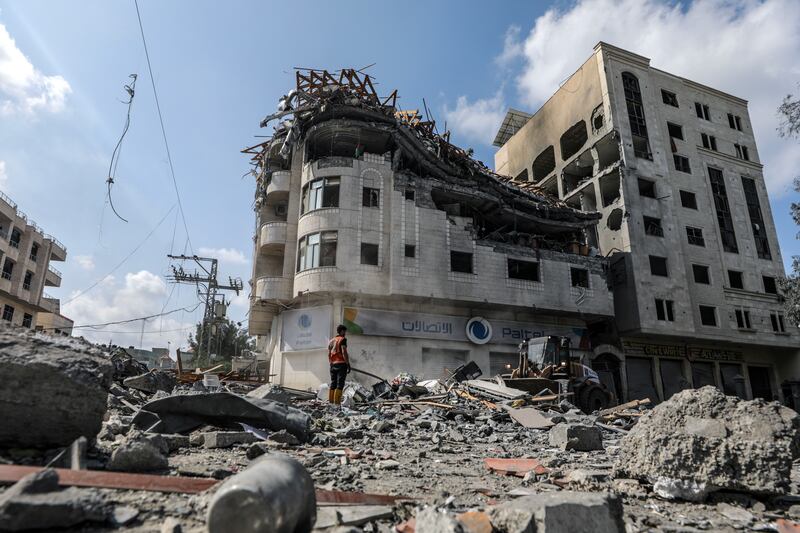 Palestinians inspect a destroyed building following Israeli air strikes in Al Ramal neighbourhood in Gaza city. EPA