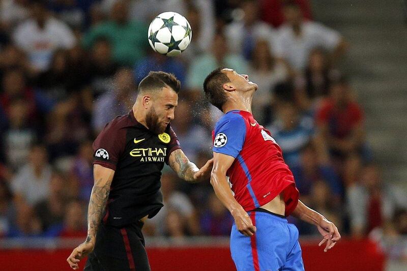 Manchester City's Nicolas Otamendi, left, and Steaua's Bojan Golubovic, right. (EPA)