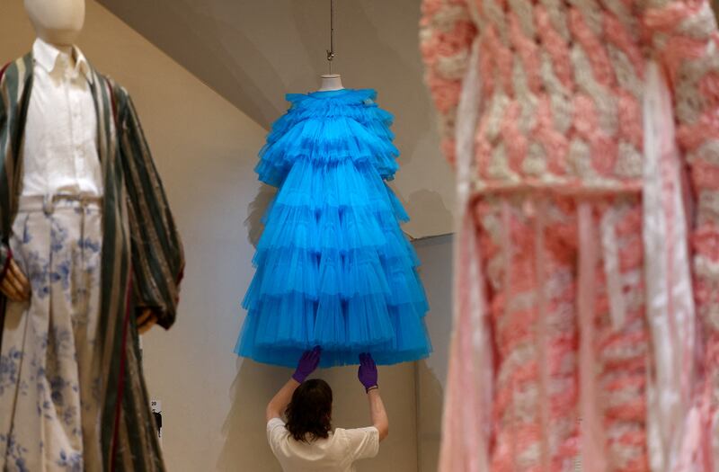 Employee Grace Morgan adjusts a design by Molly Goddard, made famous by Rihanna. Reuters