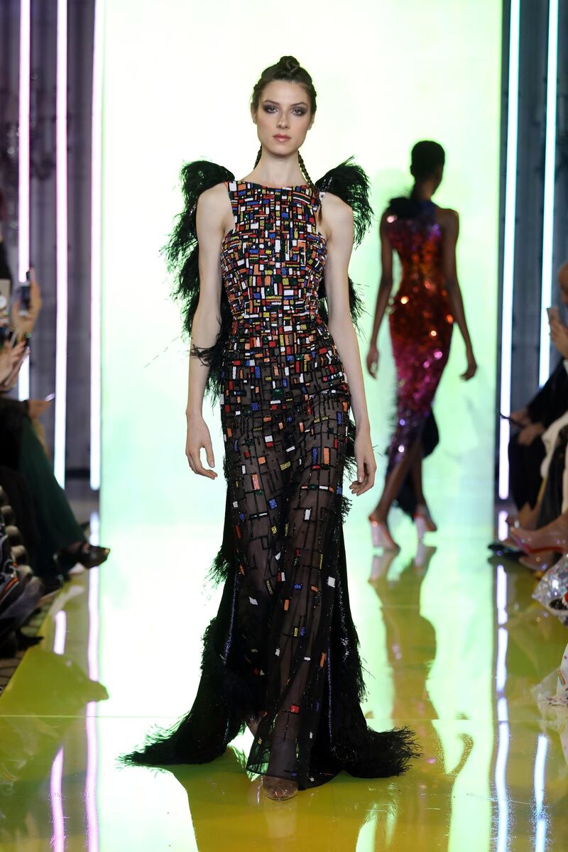 Black dress hand-embroidered with sequins and shiny beads, featuring ruffles of velvet lurex and devoré black feathers 