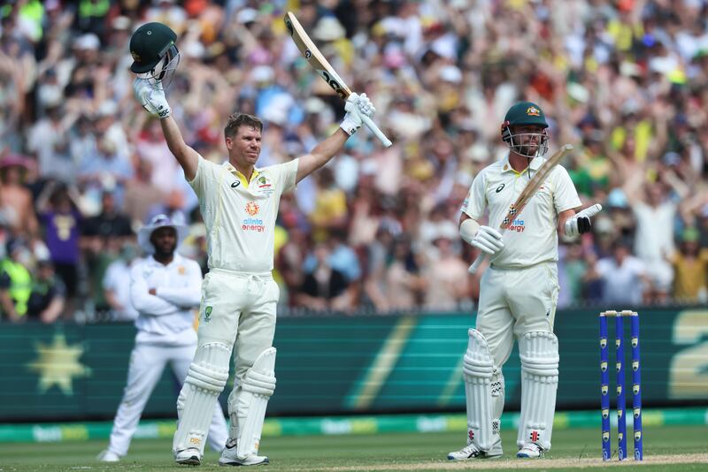 David Warner celebrates after reaching his double century and is applauded by Australia teammate Travis Head. AP