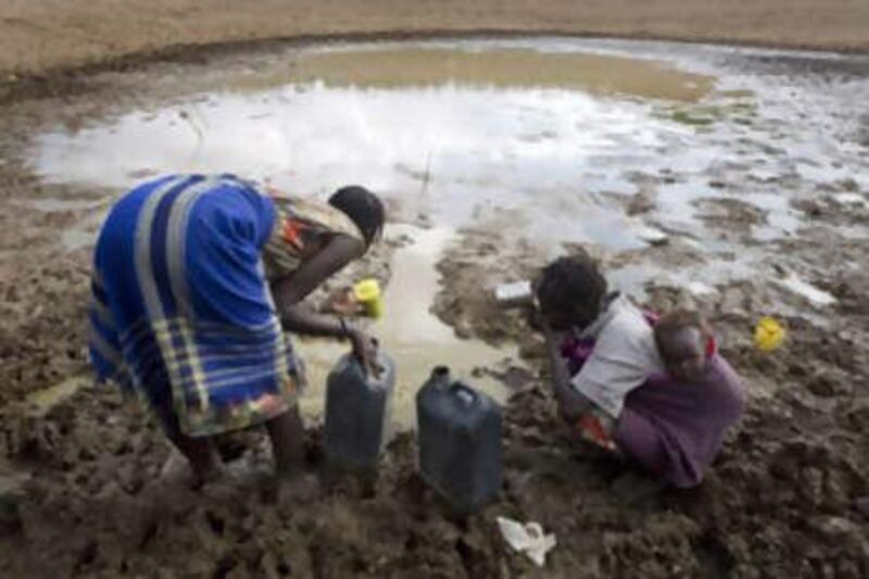 Villagers in Tangulbei in Kenya collect drinking water from a lake.