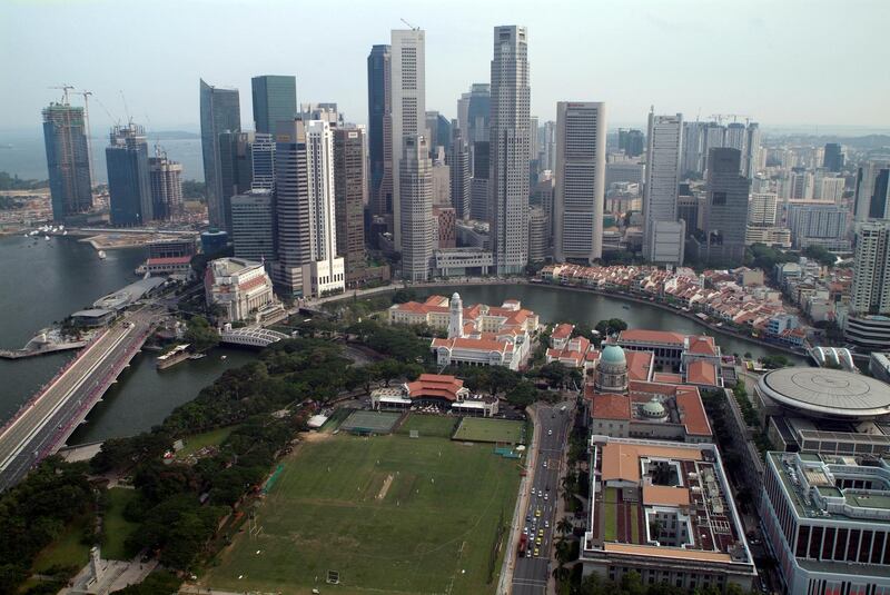 SINGAPORE - 2009/08/01: A view over the Padang Cricket Ground, the Singapore River and the Central Business District in Singapore. Much of the colonial-era architecture (seen with red roofs) was built between the 1820's and 1870's and has been maintained and restored under National heritage laws. Most of the buildings in the CBD have been built within the last 20 years.
This view is from an Executive Floor room at the Swissotel The Stamford Hotel, one of Southeast Asia's tallest hotels. (Photo by Leisa Tyler/LightRocket via Getty Images)