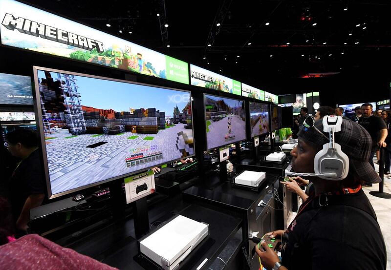 Gamers in the Microsoft Xbox exhibit play the "Minecraft" game on day one of E3 2017, the three day Electronic Entertainment Expo, one of the biggest events in the gaming industry calendar. AFP