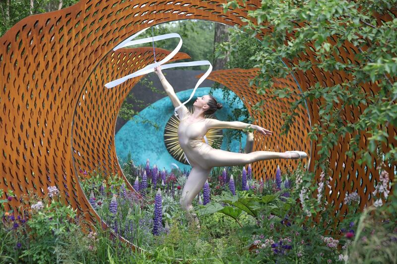 A dancer performs in The David Harber and Savills Garden at the 2018 Chelsea Flower Show in London.