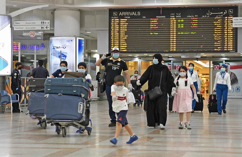 Passengers arrive at Kuwait international airport.  EPA