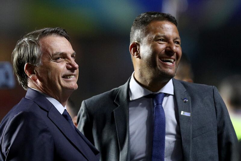 SAO PAULO, BRAZIL - JUNE 14: President of Brazil Jair Bolsonaro smiles with Washington former player of Fluminense during the Copa America Brazil 2019 group A match between Brazil and Bolivia at Morumbi Stadium on June 14, 2019 in Sao Paulo, Brazil. (Photo by Buda Mendes/Getty Images)