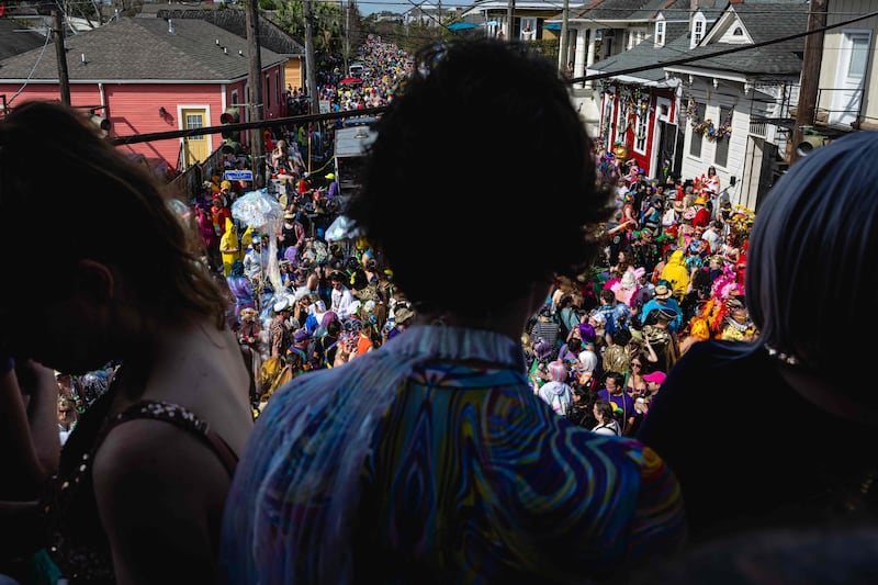 Mardi Gras revellers look out over the St Anne Parade on February 21 in New Orleans, Louisiana. Getty / AFP