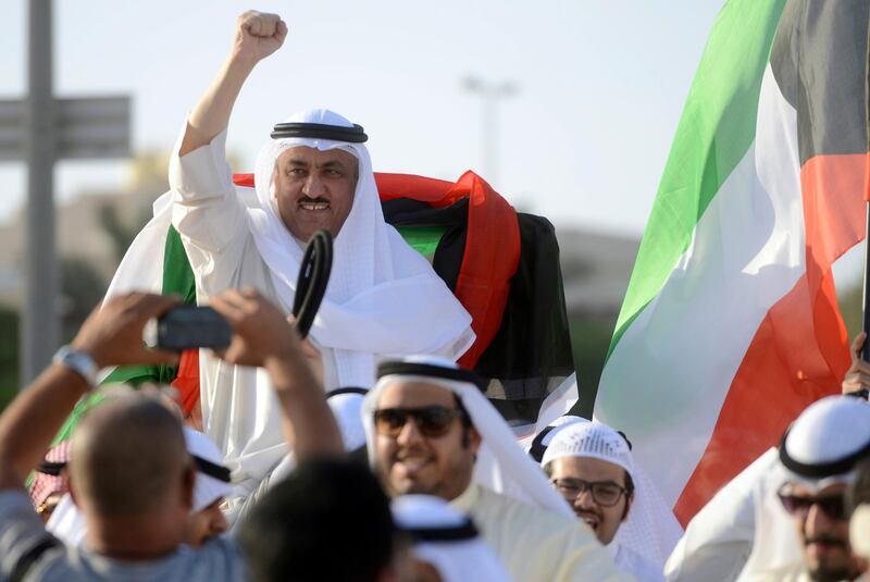 FILE - In this Monday April 20, 2015 file photo, supporters celebrate with opposition leader Musallam al-Barrack in Kuwait City after his release on bail ahead of a final decision on charges he insulted the country's ruler. A lawyer said Monday Nov. 27, 2017, that a Kuwaiti appeals court has sentenced al-Barrack to seven more years in prison, after being freed on another conviction in April this year. (AP Photo, File)
