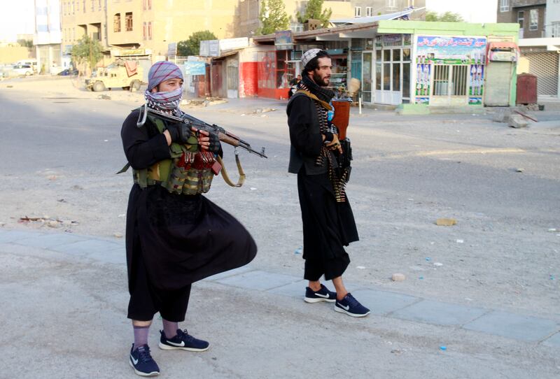 Herat's streets are deserted, apart from armed groups on patrol. AP