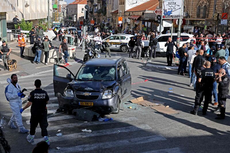 Israeli police and emergency teams gather at the scene after a car injured five people near Mahane Yehuda market, Jerusalem. AFP