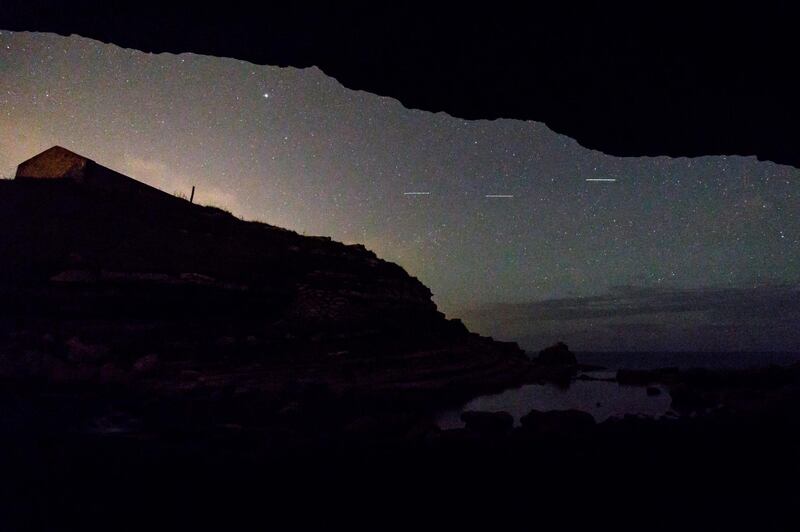 This picture taken on August 12, 2017 shows a Perseid meteor along the Milky Way illuminating the dark sky near Comillas, Cantabria community, northern Spain, during the "Perseids" meteor shower. 
Northern hemisphere sky-gazers are in for a special treat on August 11 and 13, night with a rare shooting star "outburst", which astronomers hope will not be marred by clouds and a bright Moon. / AFP PHOTO / CESAR MANSO