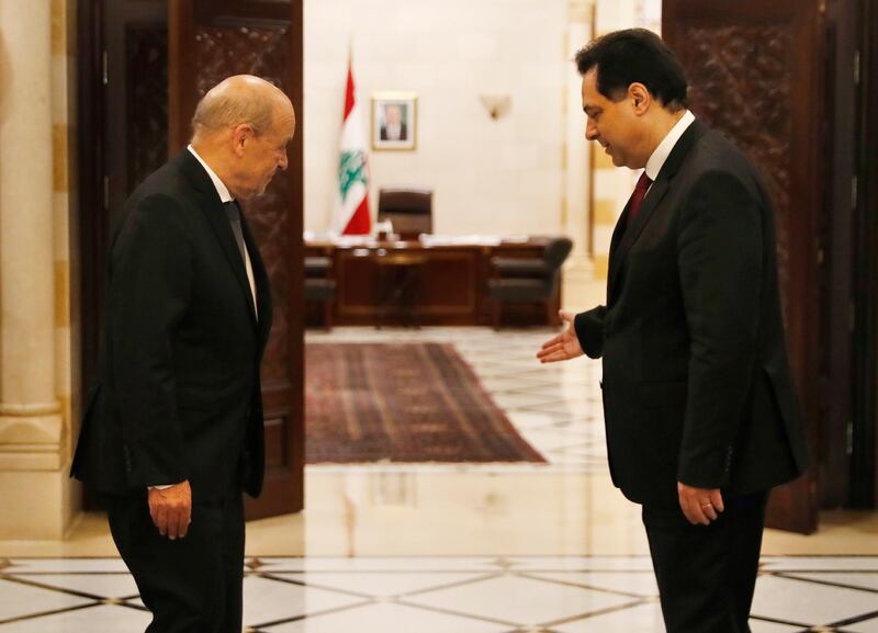 Lebanese Prime Minister Hassan Diab, right, welcomes French Foreign Minister Jean-Yves Le Drian in Beirut. AP Photo