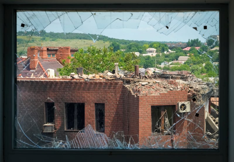 A house heavily damaged by Russian shelling is seen through a broken window, in the town of Bakhmut, Donetsk region. AP 