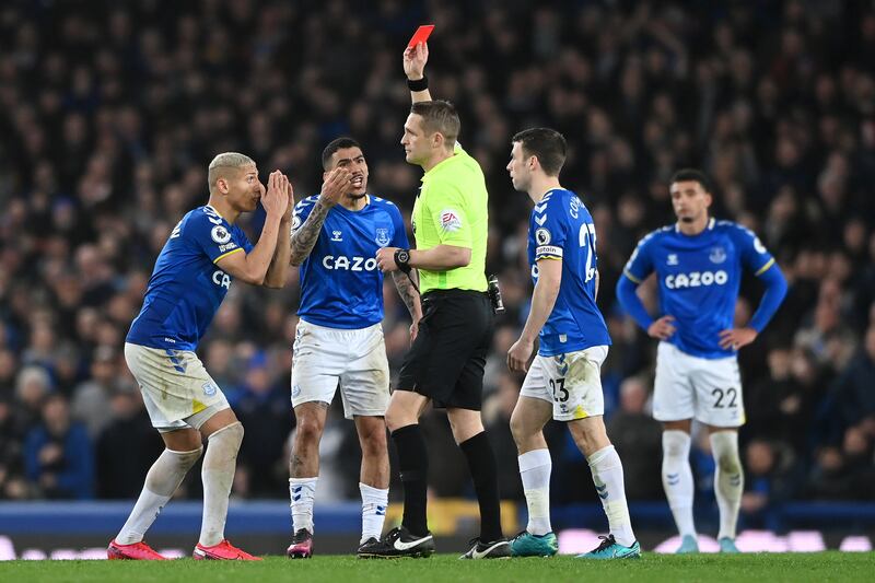 Referee Craig Pawson shows Allan a red card. Getty