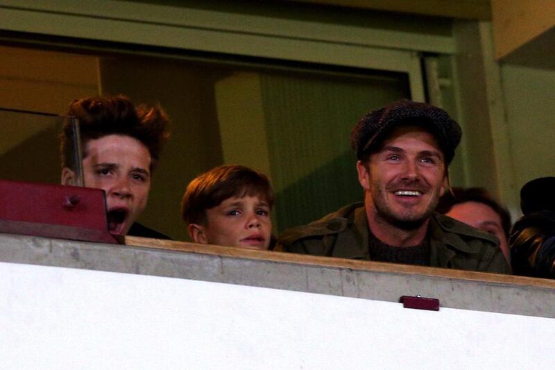 From right to left, David Beckham and his sons Romeo Beckham and Brooklyn Beckham watch the action during Saturday's Premier League match between Manchester United and West Ham United. Paul Gilham / Getty Images / March 22, 2014