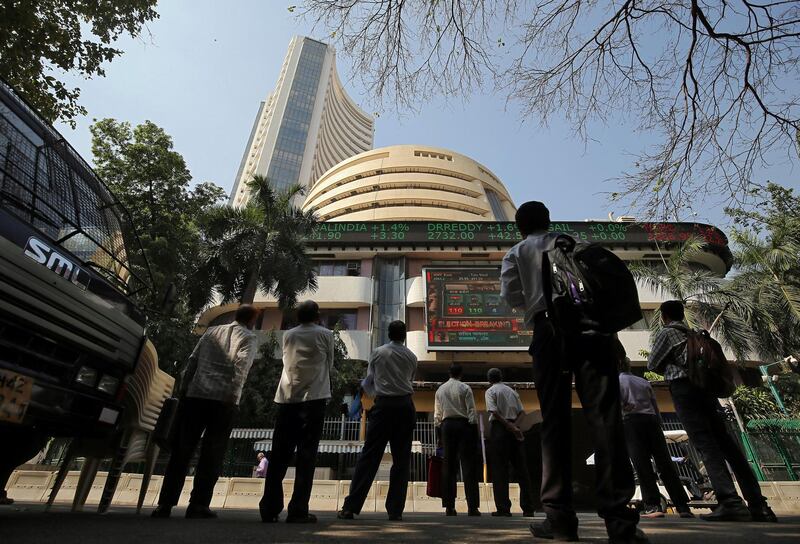 People look at a screen displaying the Sensex results on the facade of the Bombay Stock Exchange (BSE) building in Mumbai, India, December 11, 2018. REUTERS/Francis Mascarenhas