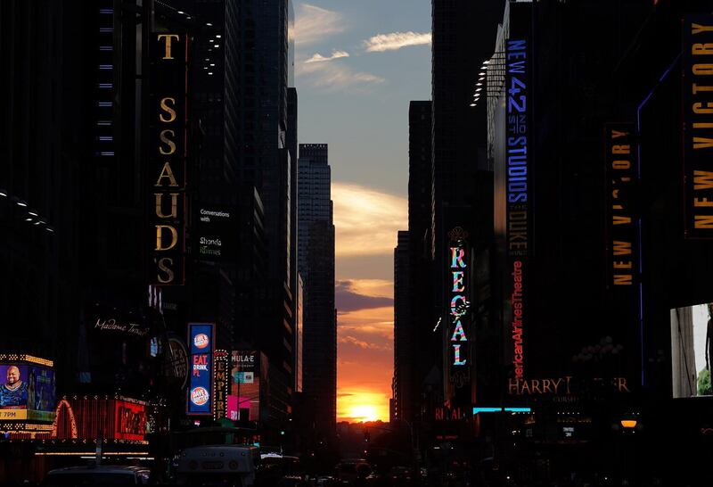 The sun sets as seen from 42nd street at Times Square in New York City. Timothy A. Clary / AFP