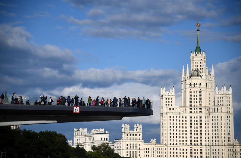 Tourists enjoy the view from an observation deck with the Kotelnicheskaya Embankment Building seen in the background, in Moscow, ahead of the Russia 2018 World Cup. Franck Fife / AFP