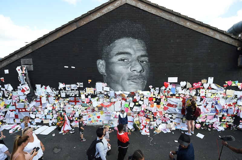 A mural of English footballer Marcus Rashford who was heralded for his lead role in a UK school meals initiative, angering some who believed sport and politics should not mix. Reuters
