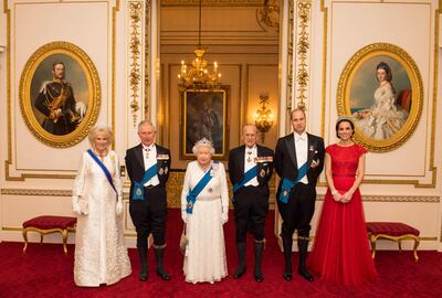 Queen Elizabeth II with her husband Prince Philip, Duke of Edinburgh, their son Britain's Prince Charles, and his wife Camilla, and their grandson Prince William, and his wife Catherine, on December 8, 2016, at Buckingham Palace, London. POOL / AFP