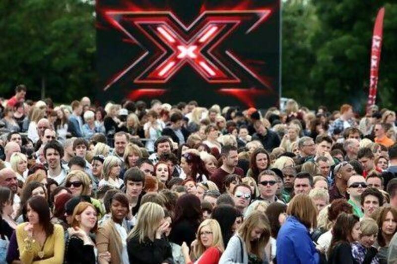 Hopeful performers queue as X Factor judges arrive for the first auditions at the LG Arena, Birmingham. (PA Wire / Press Association Images)