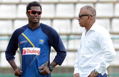 Sri Lanka's captain Angelo Mathews (L) speaks with team manager Charith Senanayake during a practice session at the Pallekele International Cricket Stadium in Pallekele on July 24, 2016.
Sri Lanka are due to play three Tests against the visiting Australians, with the first starting in Pallekele on July 26.  / AFP PHOTO / LAKRUWAN WANNIARACHCHI