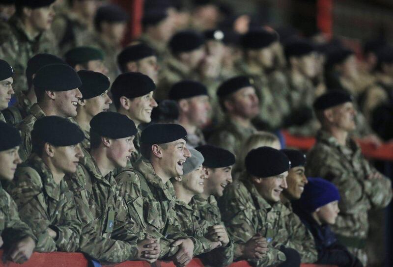 British Army soldiers watch their team playing against the German army in Aldershot, England on Wednesday. Lefteris Pitarakis / AP