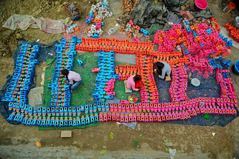 Potters paint traditional earthen oil lamps in Jalandhar. AFP