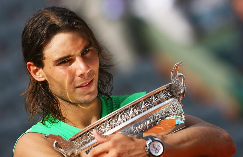 PARIS - JUNE 08:  Rafael Nadal of Spain hugs the trophy following his victory during the Men's Singles Final match against Roger Federer of Switzerland on day fifteen of the French Open at Roland Garros on June 8, 2008 in Paris, France.  (Photo by Julian Finney/Getty Images)