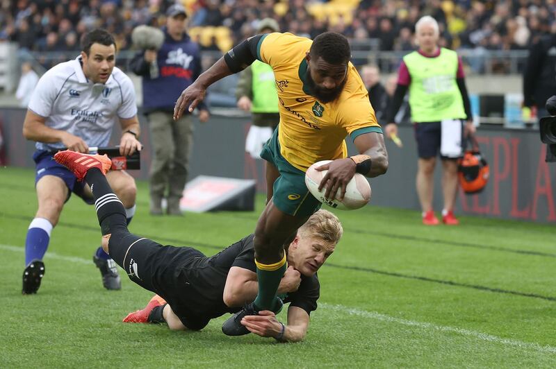 New Zealand's Damian McKenzie (L) tackles Australia's Filipo Daugunu as he scores a try during the Bledisloe Cup rugby union match between New Zealand and Australia in Wellington. AFP