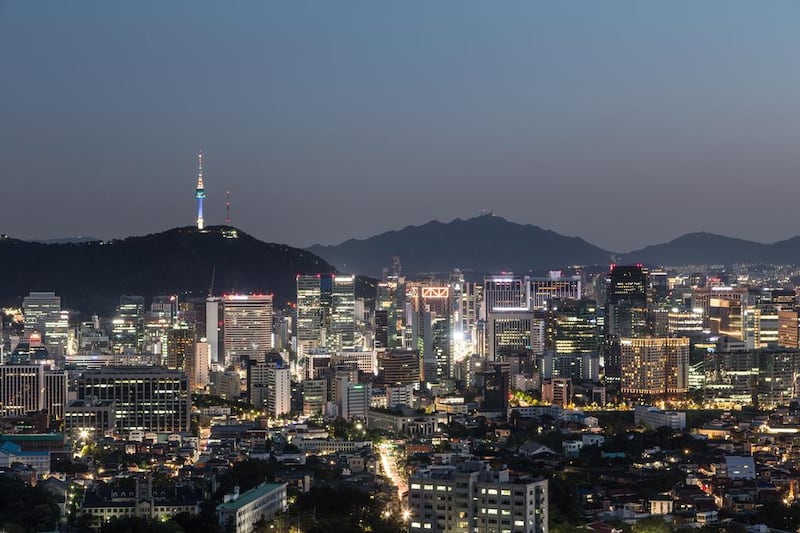 An aerial view of Seoul business district at night with the Namsan mountain with the Seoul Tower in the background. (Getty Images)